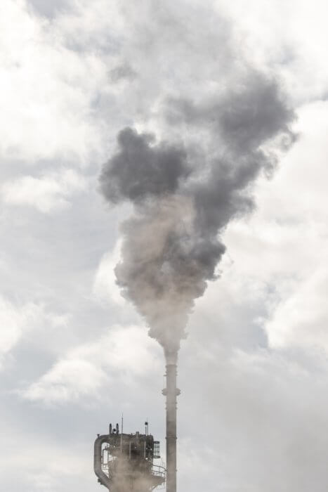 Photograph of a factory chimney and smoke