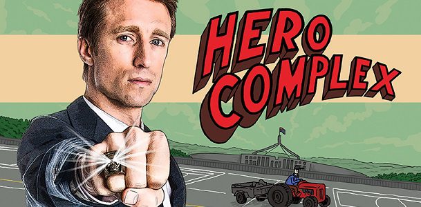 A cartoon of Sammy J standing outside of Parliament House with words 'Hero Complex'