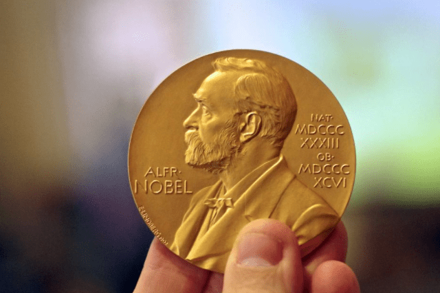 a hand holding a nobel prize