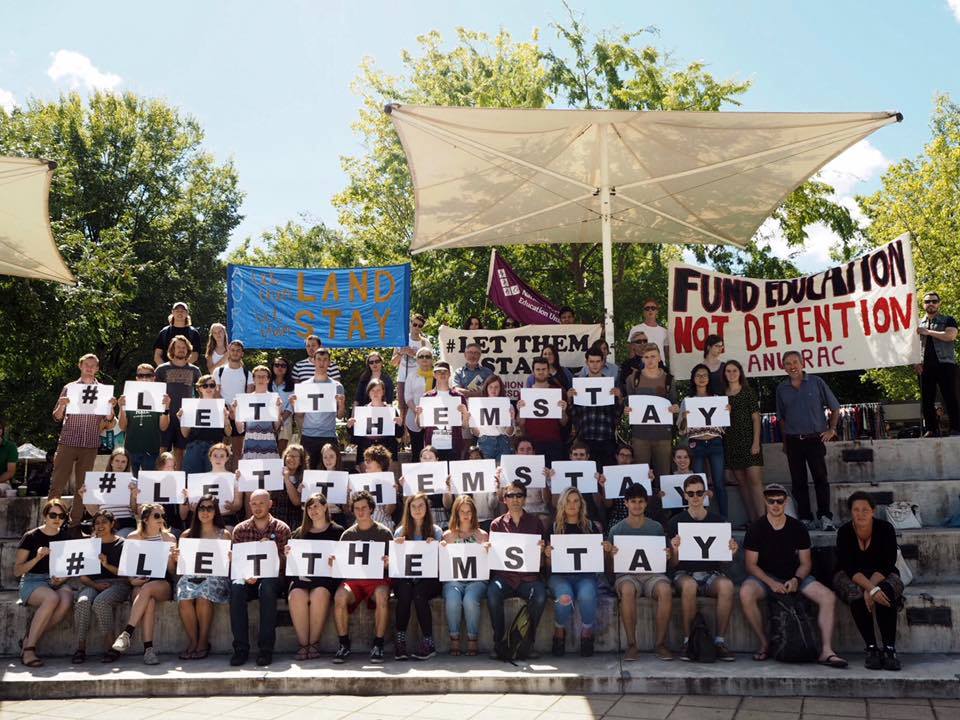 ANU Refugee Action Committee holding signs in a peaceful protest to close detention camps