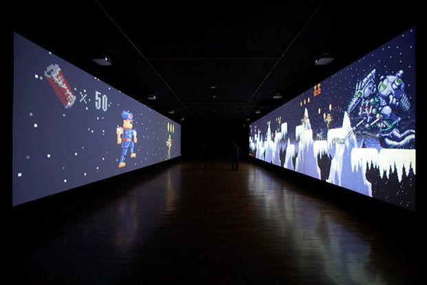 dark corridor with video games on the walls, art installation at Museum of Modern Art