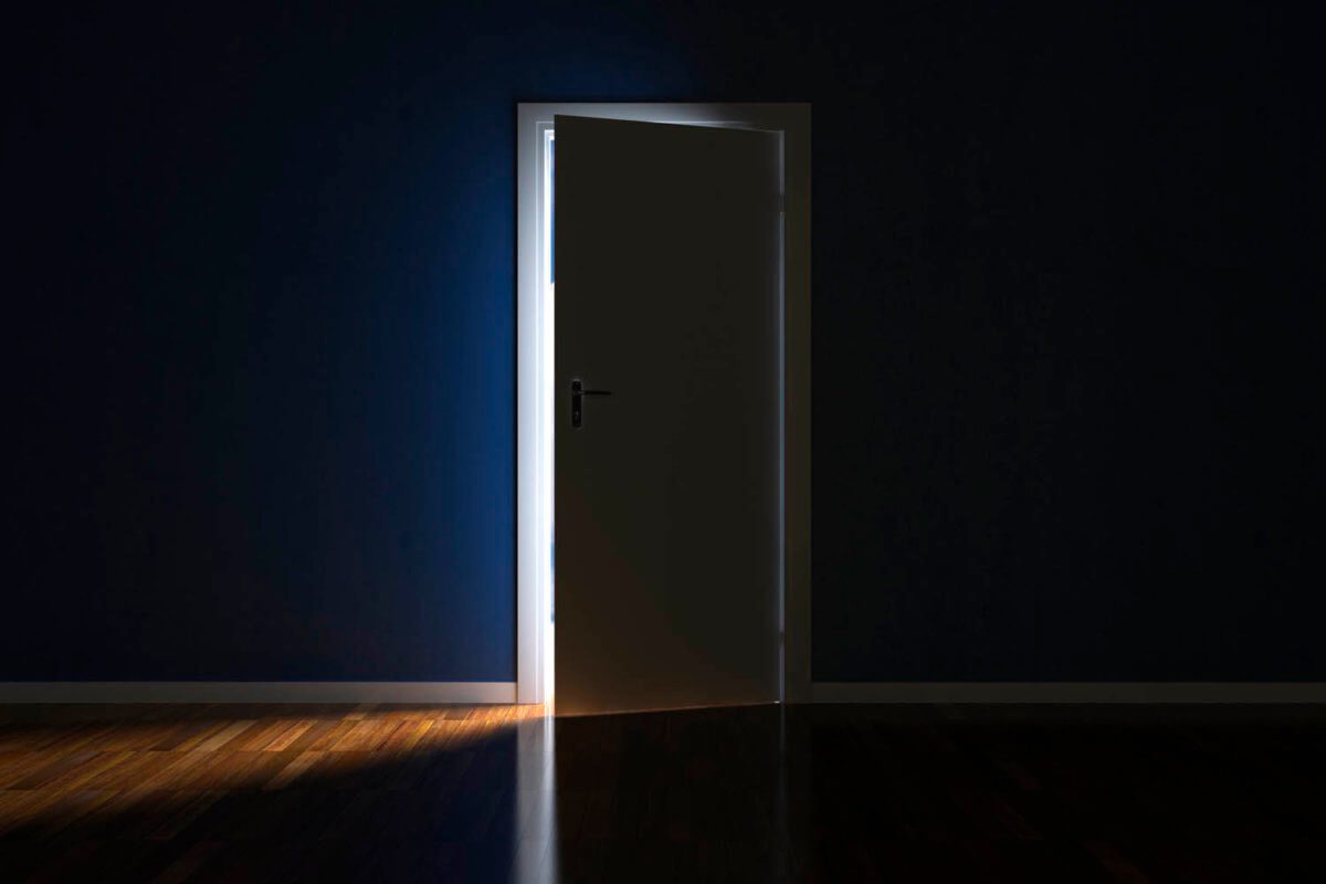 a door open to let a sliver of light through