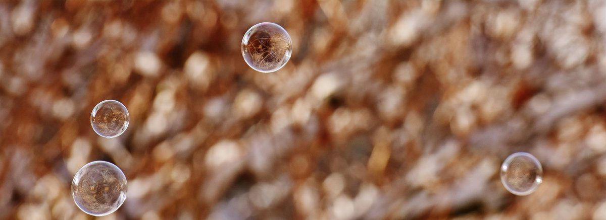 Three bubbles floating against a brown background.