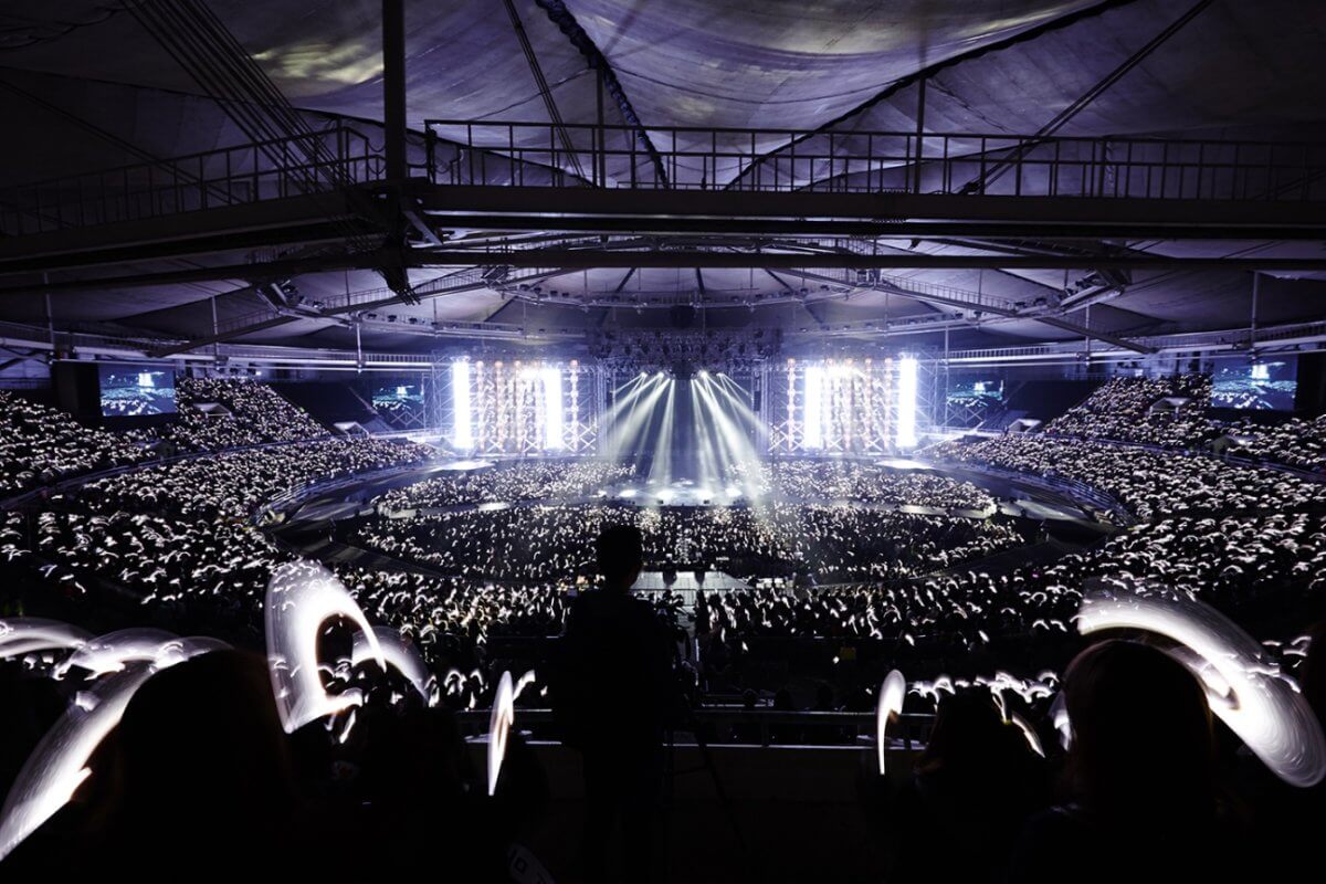 A K-pop concert in a stadium with light sticks