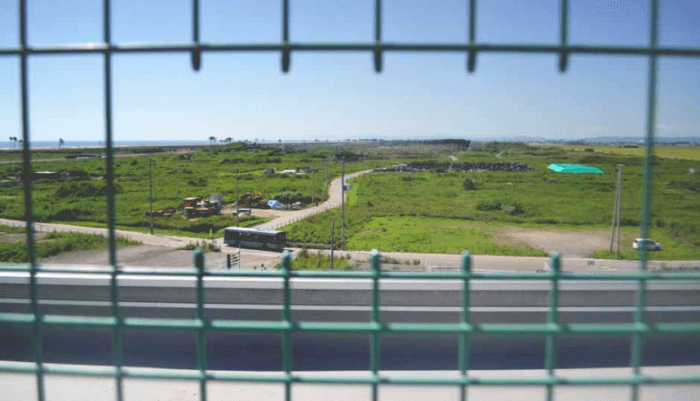 he scene from the roof of the Arahama Elementary School. The black patch in the distance is the cemetery