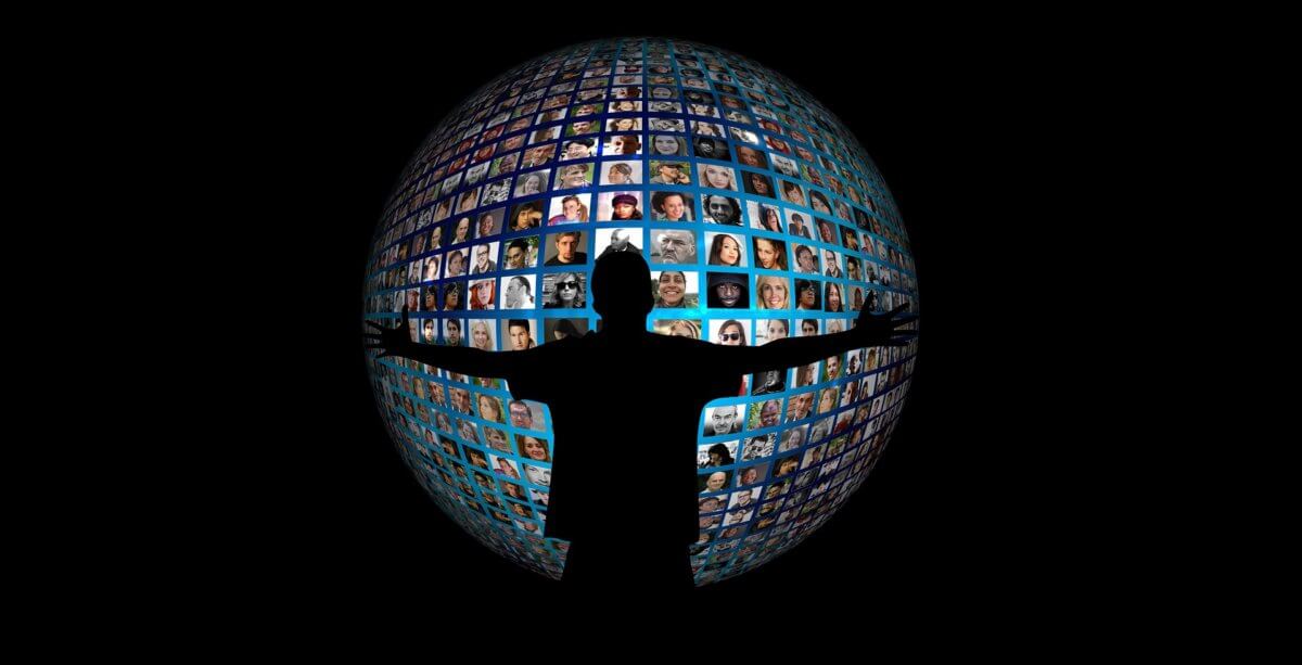 A silhouette of a person stands, arms outstretched, in front of an array of social media profile pictures arranged to look like a globe