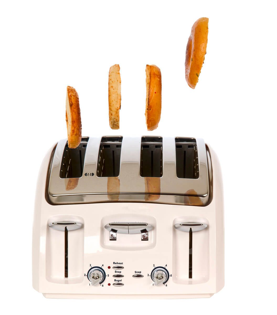 Four bagels popping out of a metallic toaster.