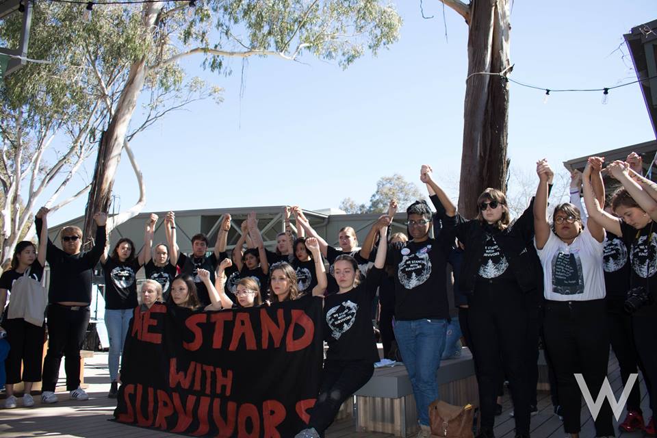 student advocates holding raised hands