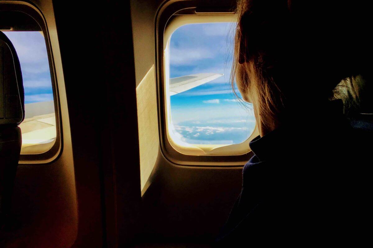 a person looking out of an airplane window