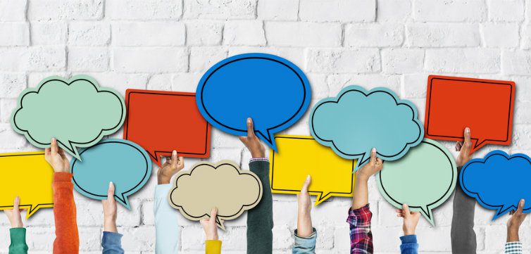 hands holding up speech bubbles