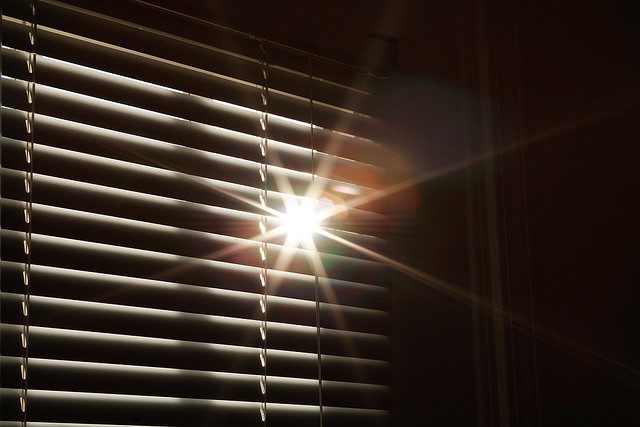 Sunlight shining through some horizontal blinds