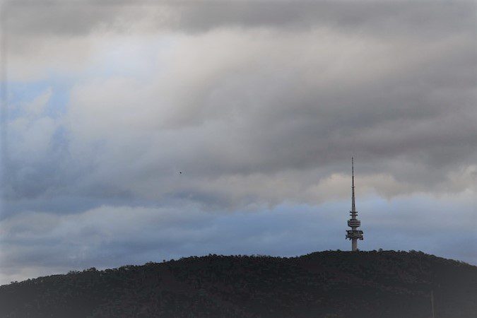 Image of Telstra tower in Canberra surrounded by clouds.