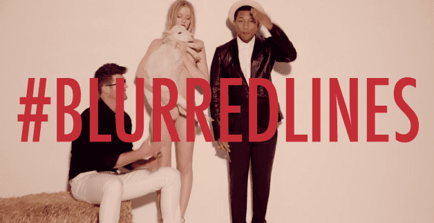Pharell Williams and Robin Thike in a still from their music video released for blurred lines with "#blurredlines" printed in red over the image