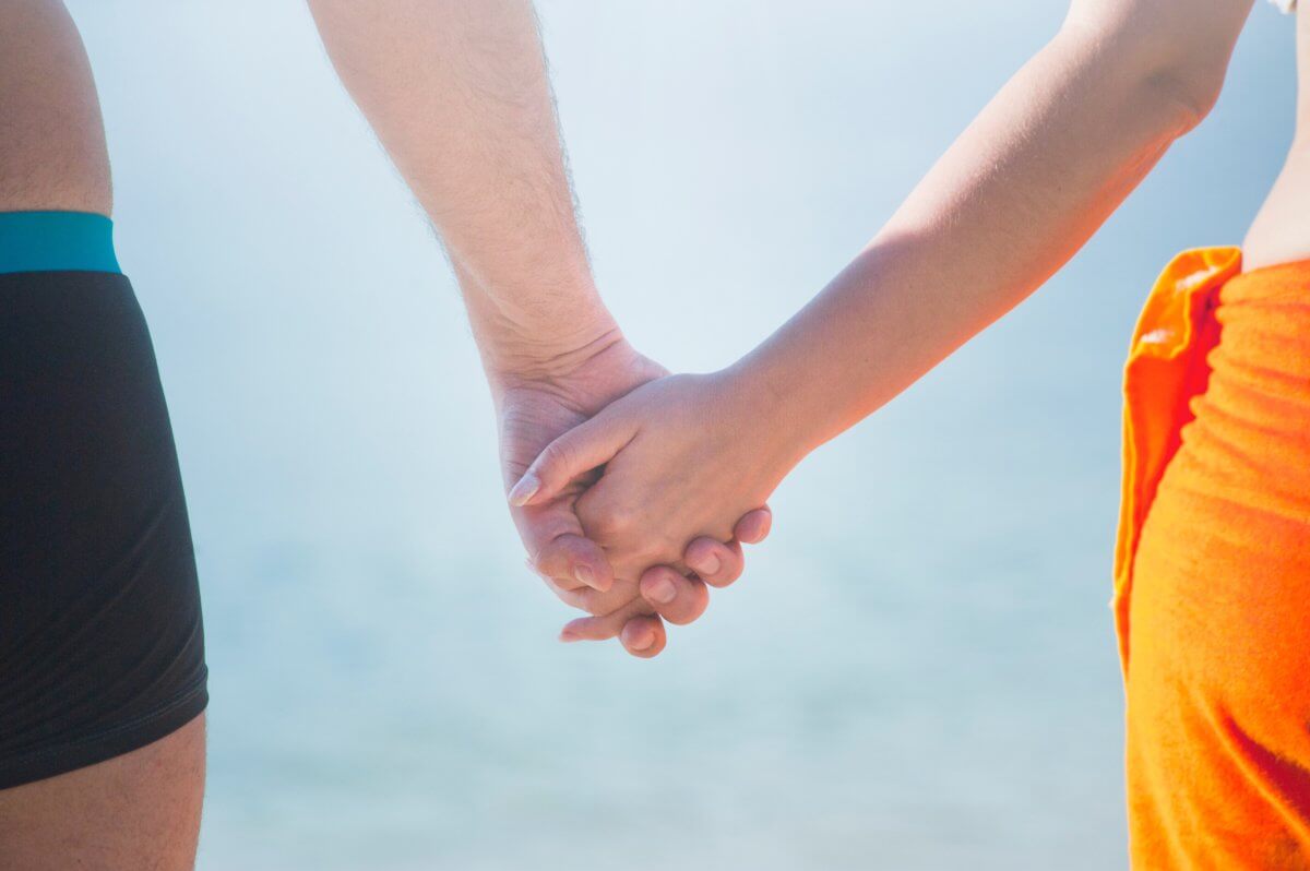 A photo of a couple holding hands