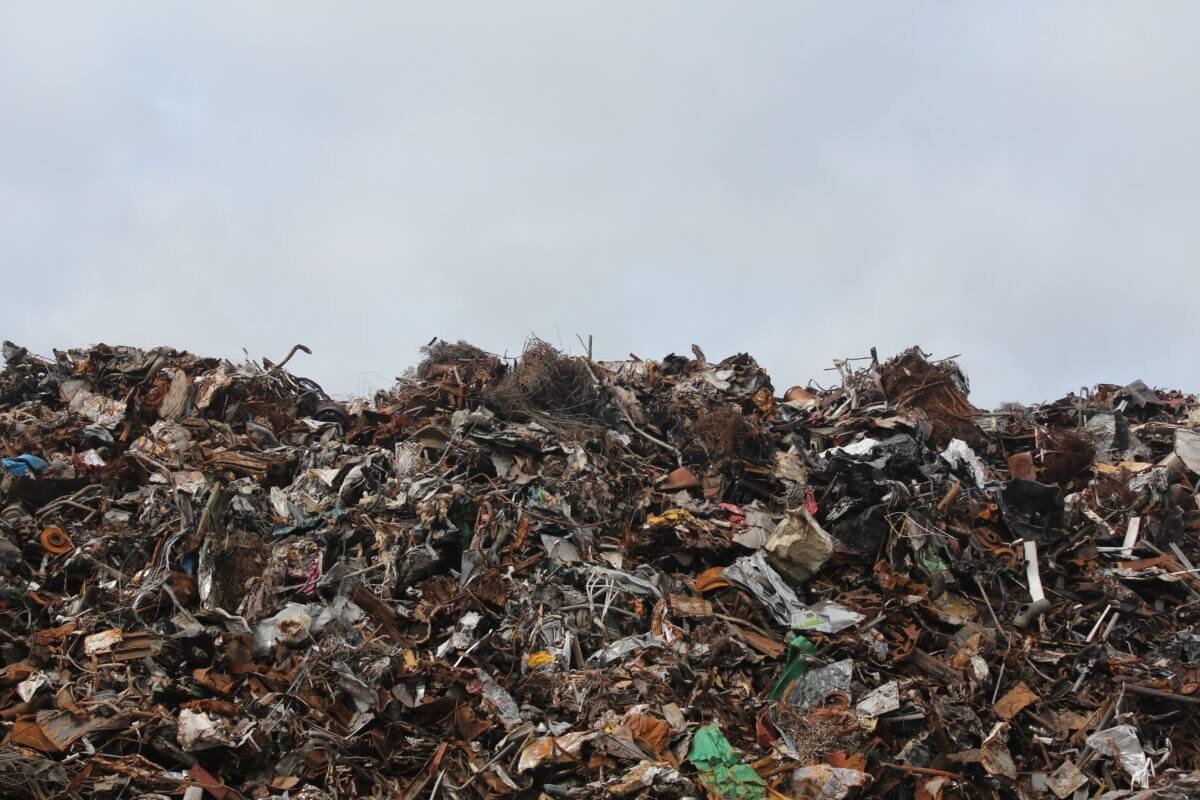 A large pile of rubbish, taking up two thirds of the picture, with a grey sky in the top third