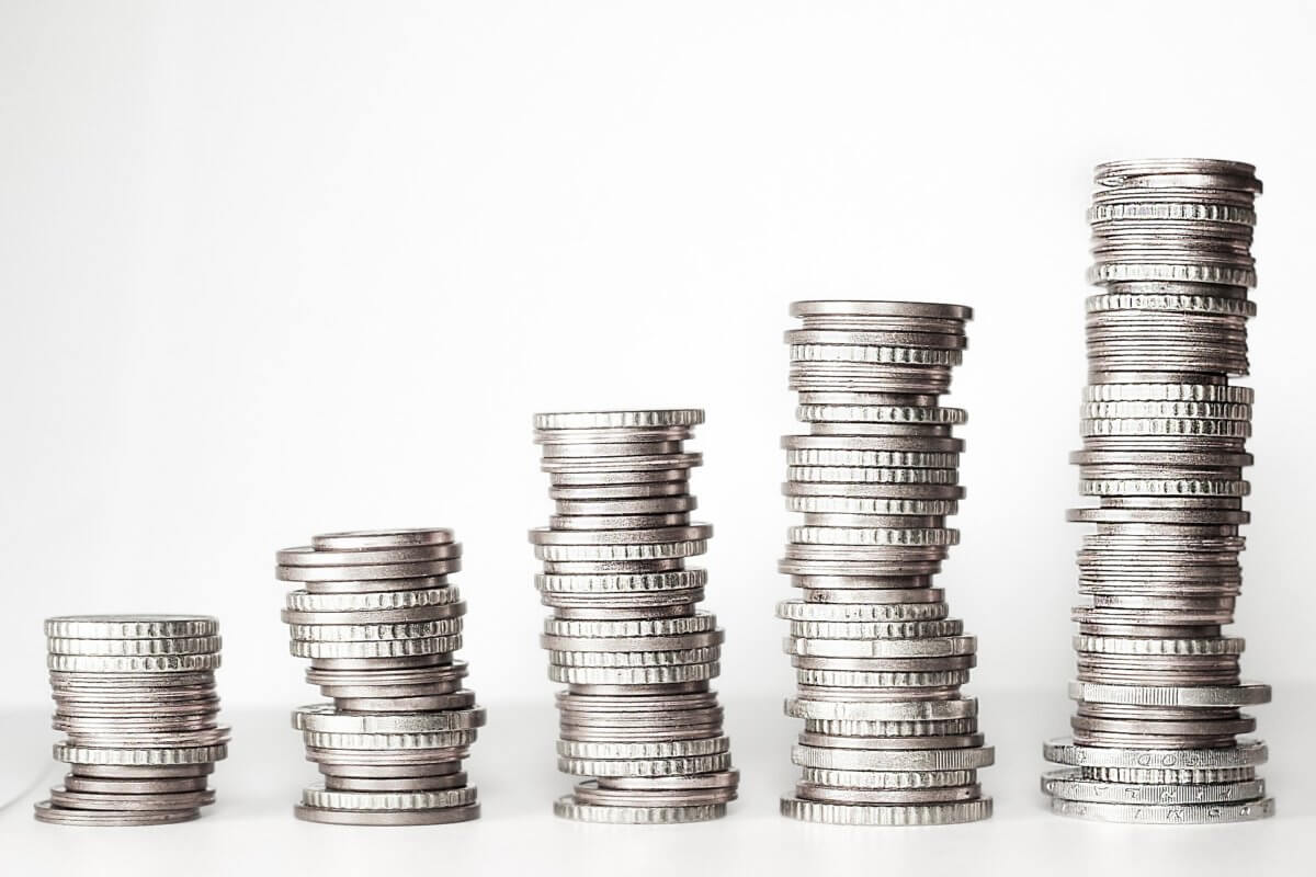 An photograph of silver coins stacks progressively getting higher