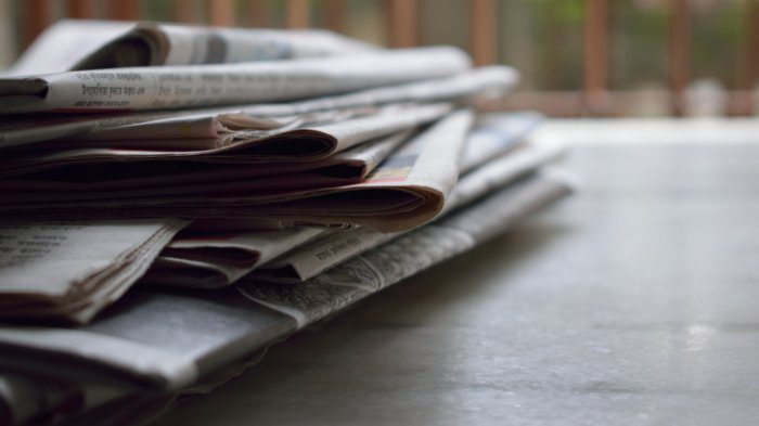 Stack of newspapers on desk