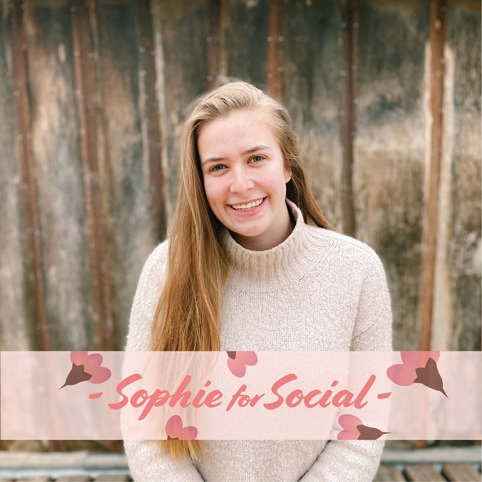 A photograph of a smiling blonde woman in a white sweater. Pink text in a banner reads 'Sophie for Social' and pink flowers surround it
